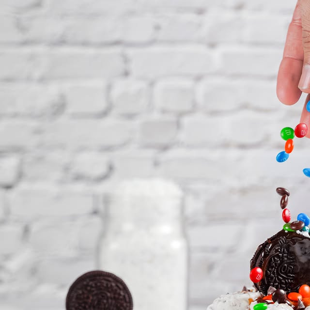 Oreo ice cream rolls with M&Ms and colorful toppings